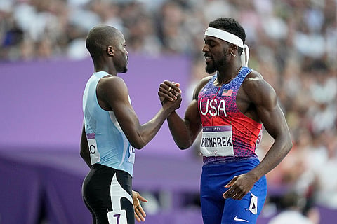 Gold medalist Letsile Tebogo and silver medalist Kenneth Bednarek after finishing the men's 200 meters final 